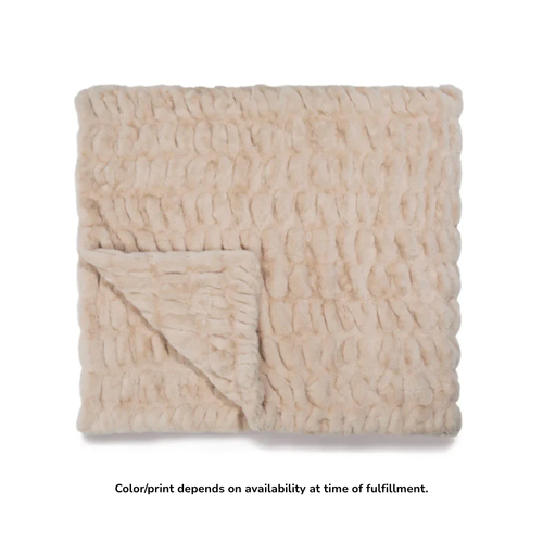 Beige plush Lola blanket with soft fur texture and a folded corner.