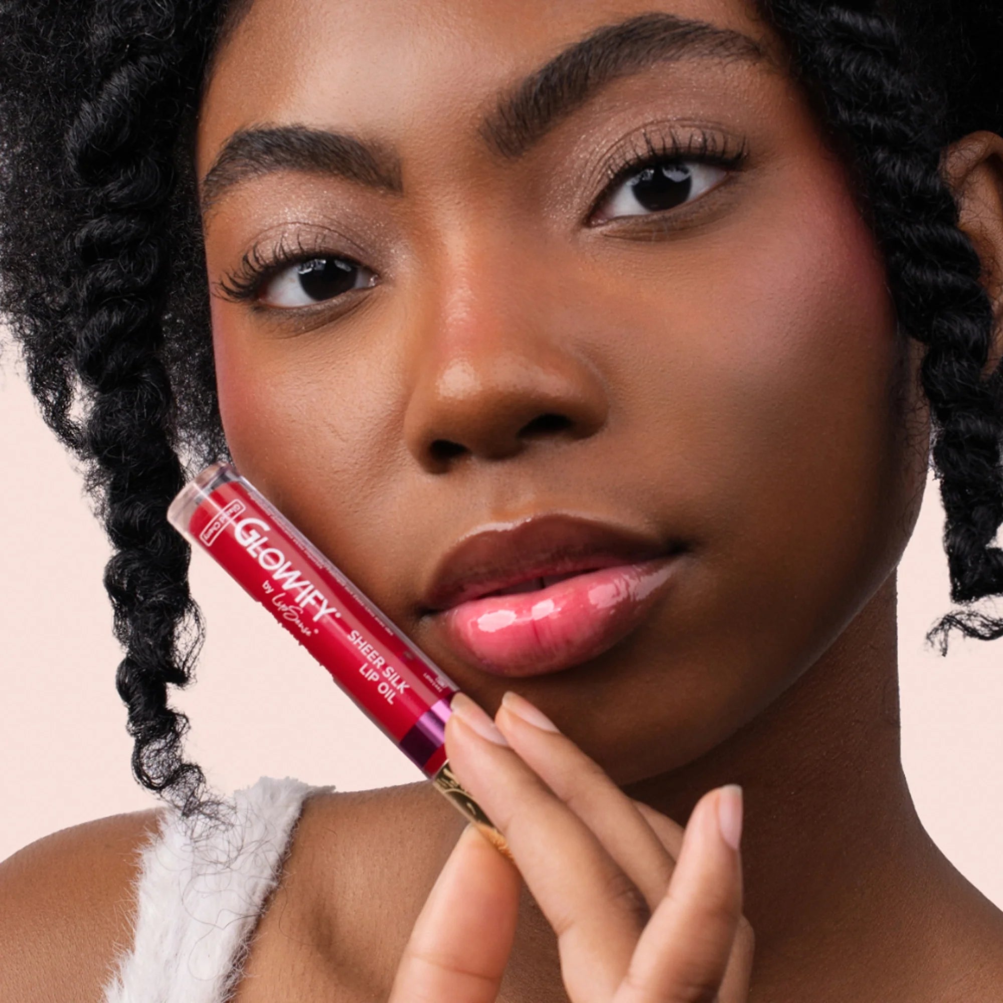 Model wearing Glowify Sheer Silk Lip Oil product shade Glazed Cherry.
