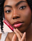 Model wearing Glowify Sheer Silk Lip Oil product shade Glazed Cherry.