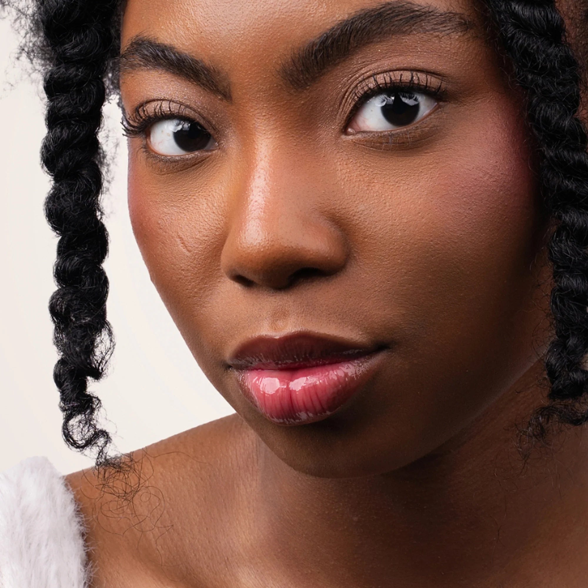 Model wearing Glowify Sheer Silk Lip Oil product shade Silk Berry.