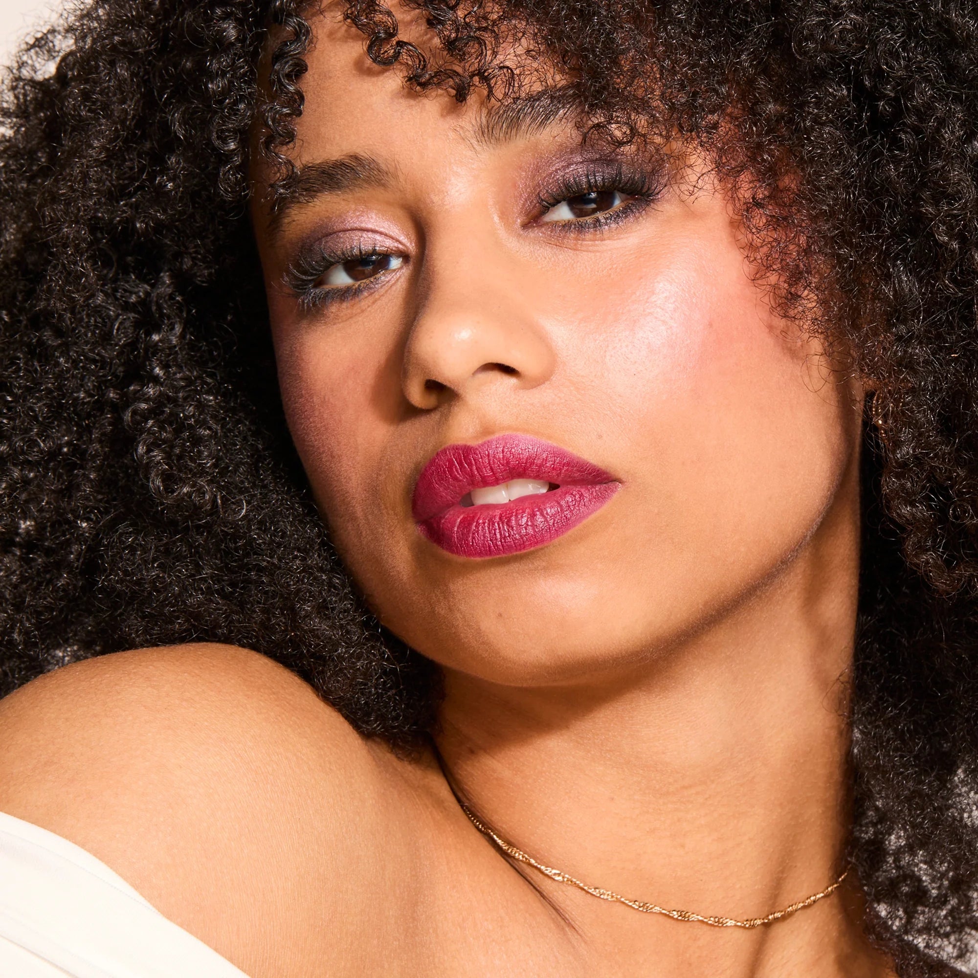 Model wearing LipSense Cream product shade Boysenberry Satin.