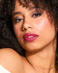 Model wearing LipSense Cream product shade Boysenberry Satin.