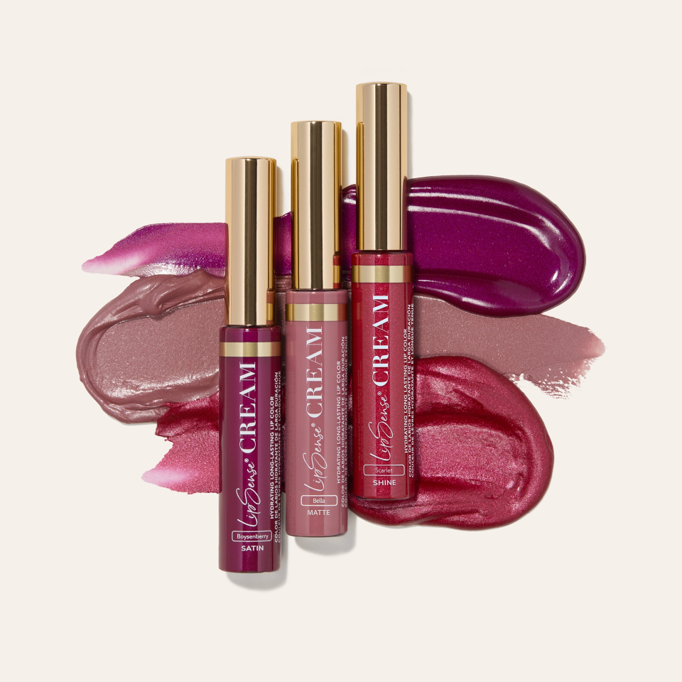 Assorted lip glosses in pink and red with gold caps from Beauty Book January 2026 Edition.