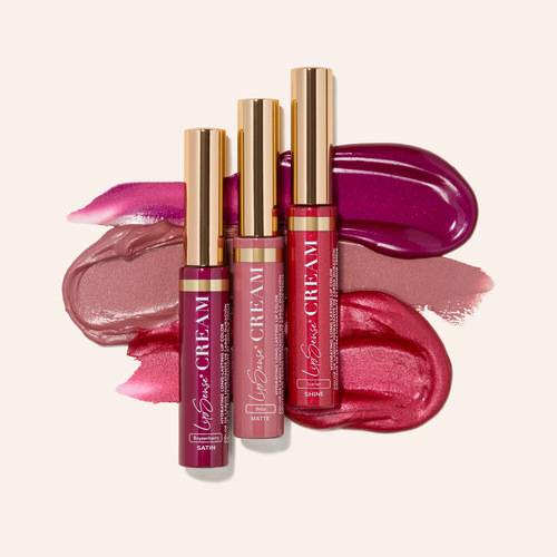 Assorted lip glosses in pink and red with gold caps from Beauty Book January 2026 Edition.
