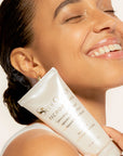 Model holding SeneGence Microbiome Correcting Cleanser product.