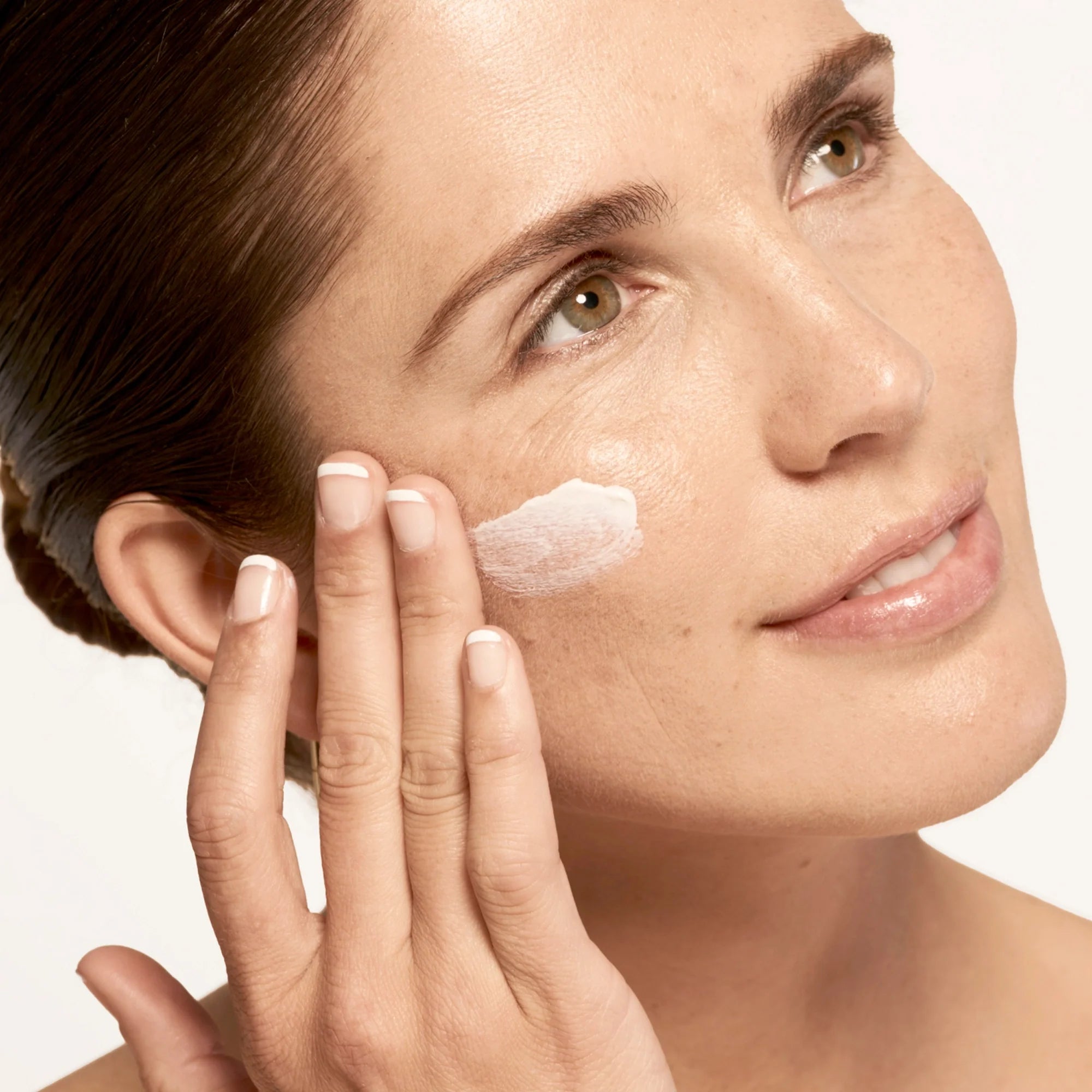 Model applying Microbiome Defense Daytime Moisturizer SPF 15.