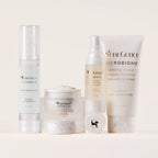SeneGence Microbiome regimen set with four white skincare products arranged on a neutral backdrop