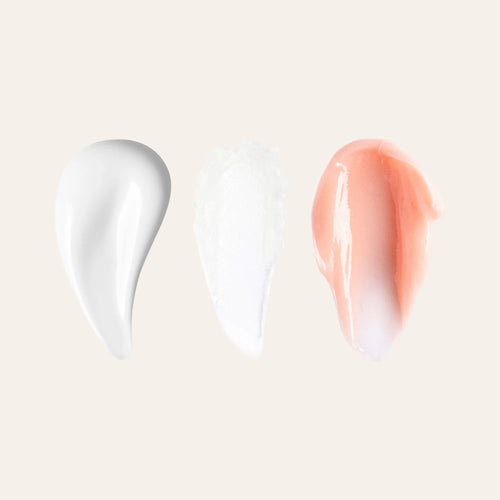 Three lip care swatches on a beige background white cream white balm and peach tinted cream